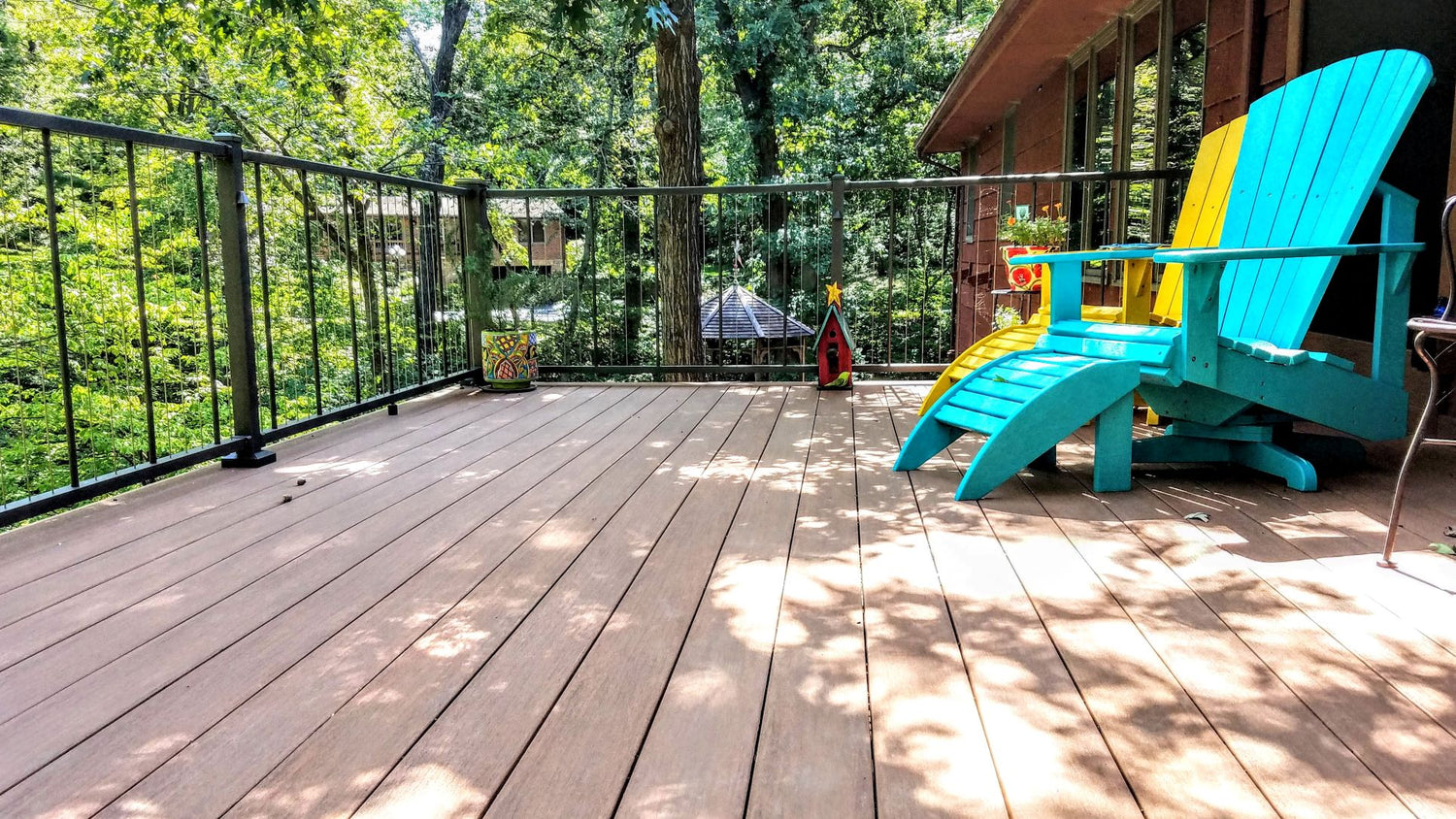 beautiful outdoor deck area with blue and yellow chairs. verticable c80 fine texture bronze