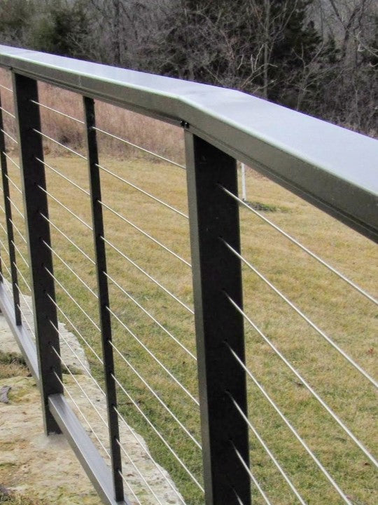 DesignRail aluminum and stainless steel horizontal cable with series 200 on curved bluff with posts core drilled into stone Deck & Rail Supply has been selling designrail like this for years! This railing was installed in 2014 in Overland Park, Kansas